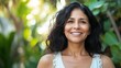 © Bijac - portrait of a radiant middle-aged hispanic woman outdoors, smiling confidently amidst a backdrop of lush greenery, embodying positivity and cultural pride