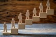 © Vitalii Shkurko - Small wooden figures ascend a series of blocks arranged like stairs, representing the journey of personal growth and continual improvement over time