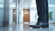 © StockPick - Business Professionals Entering Executive Meeting - Focused Team Preparing for High-Stakes Discussion in Elevator Polished Shoes Reflecting Professionalism