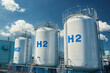 © Александр Марченко - Hydrogen gas storage tanks providing sustainable clean energy under blue sky
