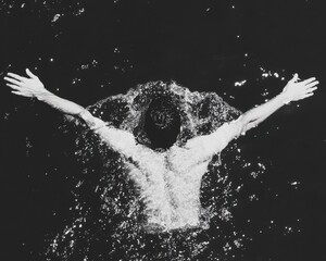 Swimmer Breaking Through Water Surface in Dramatic Style