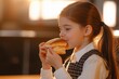 © Maelgoa - A young girl in a school uniform eating a cheese panini, cafeteria background, bright lighting 1
