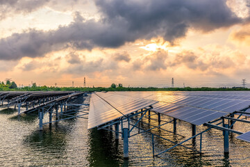 Wall Mural - Solar panels on river and cloudscape at sunset