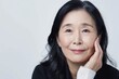 © Isuru - Portrait of happy Asian woman promoting skincare and spa products.