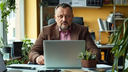 Poster - Focused corporate businessman engaged with laptop in modern office environment