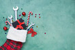 © Pixel-Shot - Composition with Christmas sock, gift box and wrenches on green background