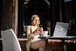© DZ FILM/Stocksy - A woman works sitting on a coffee terrace