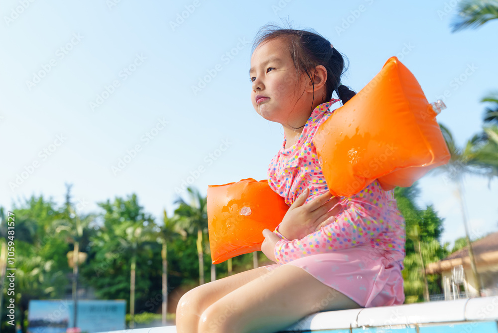 cute little asian girl sitting by the swimming pool Stock Photo | Adobe ...