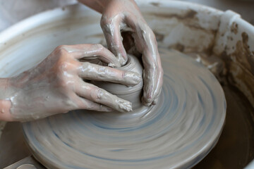 Making of mud pot on potters wheel during workshop in art ceramic atelier in Poland