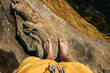 © Luis Herrera/Stocksy - pov man barefoot standing on a rock with water