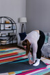 © Oleksii Syrotkin/Stocksy - Plus size woman improving flexibility by doing stretching at home