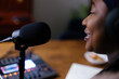 © Oleksii Syrotkin/Stocksy - Close-up of black female podcaster speaking into microphone