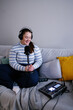 © Oleksii Syrotkin/Stocksy - Plus size woman in headphones smiling while hosting live streaming