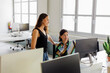 © BONNINSTUDIO/Stocksy - Two businesswomen collaborating on a project in a modern office