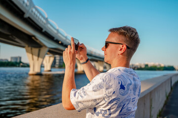 Wall Mural - Young man near the Yacht pedestrian bridge under the automobile bridges, child in the big city, St. Petersburg