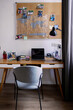 © Oleksii Syrotkin/Stocksy - Home workspace of blackboard over desk with open laptop with graph