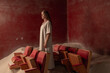 © Basil Pind/Stocksy - Woman Standing Thoughtfully Among Vintage Theater Seats
