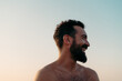 © Lucas Ottone/Stocksy - Smiling bearded man portrait