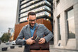 © Miljan Živković - Portrait of handsome businessman puts the phone in briefcase