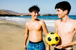 © Adrian Rodd/Stocksy - Teenage brothers laugh together at Papagayo Beach
