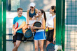 © Adrian Rodd/Stocksy - Athletes share quality time together outside the paddle tennis courts