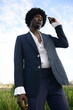 © Ogoh Clement/Stocksy - Portrait of Model on afro wearing a blue suit