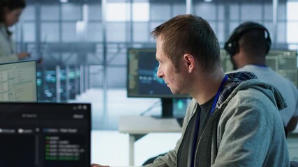 Poster - IT technician looking at PC screen, working in network security data center, ensuring optimal performance. Man supervising server hub, monitoring energy consumption across rigs, camera A