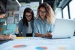 © Odin AI - Two young women analyze charts and graphs at a workspace, reflecting teamwork and collaboration in a modern business environment.