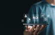 © Pakin - ROI Return on investment concept, invest money and calculate profit. Man showing ROI icon on virtual screen for investment of some resource yielding a benefit. investment business.