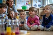 © Daria - Nursery school children engaged in classroom science experiment with teacher demonstration