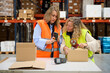 © alvaro - Warehouse workers using barcode scanner and packing cardboard boxes