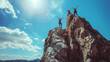 © MikeLegend - Adventurers celebrating triumph atop a rocky peak under a bright sky in the mountains on a sunny day