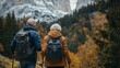 © Oscar - Elderly couple hiking through a scenic trail, holding walking sticks and looking out at the beautiful view