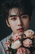 © Rudsaphon - Pensive Korean Youth Holding Romantic Floral Bouquet in Moody Studio Portrait