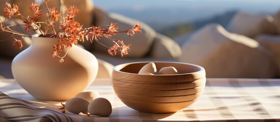 Wall Mural - A serene still life featuring a wooden bowl of eggs and a vase with autumn leaves.