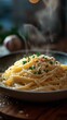 © EddieSnapix - Delicious creamy pasta is served hot, garnished with grated cheese and fresh herbs. The dish emits steam, creating an inviting atmosphere in a cozy dining setting