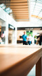 © Rysak - wooden table the center a busy indoor space