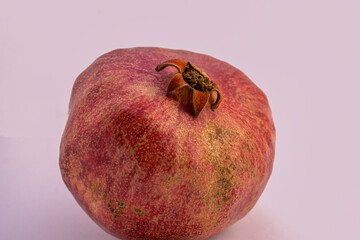 Pomegranate fruit on white background, close up.