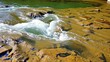 © PuriStudio - Crystal clear water flowing over smooth river rocks, creating a serene and peaceful natural scene, scenic, fresh