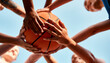 © peopleimages.com - Basketball, hands together and players with ball for fitness, support or motivation in outdoor activity. Sports game, huddle and group of people in low angle for teamwork, exercise or training match