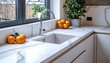 © Anastasiia - Stylish white minimalistic kitchen with quartz countertop and vibrant oranges
