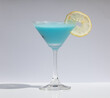 © Kamitana - Cool and Refreshing Blue Margarita in Classic Martini Glass. Ideal for visual content focusing on refreshing drinks for warm weather.