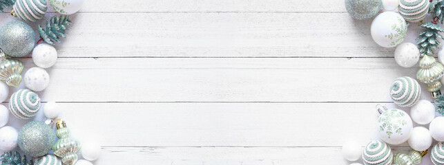 Poster - Christmas double border of white and soft green decorations. Above view on a white wood banner background. Copy space.