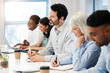© aLListar/peopleimages.com - Business, people and happy with writing at workshop for information, knowledge and training. Diversity, employees and smile or excited as audience for presentation, staff meeting and seminar