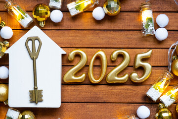 Golden figures number 2025 and tiny home on background of cozy windows of a house with warm light with festive decor of stars,snow and garlands. Greeting card, Happy New Year, cozy home