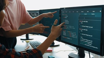 Slow motion back end software developer engineer for computer programming working together on debugging writing computing code, solving complex algorithms display on monitor in office. Burgeoning