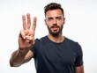 © useful pictures - Man Showing Three Fingers Against a Plain White Background While Looking Confidently Into the Camera During a Studio Session
