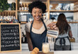 © peopleimages.com - Barista, woman and milk in coffee in cafe for customer order, cappuccino preparation or happy for service. Small business, waitress or smile with latte process on counter in bistro for caffeine drink