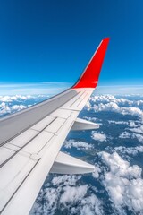 Wing of an airplane during flight over a cloudy sky