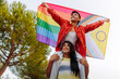 © Alberto - Happy non-binary couple celebrating lgbtq pride with LGBTQIA flag